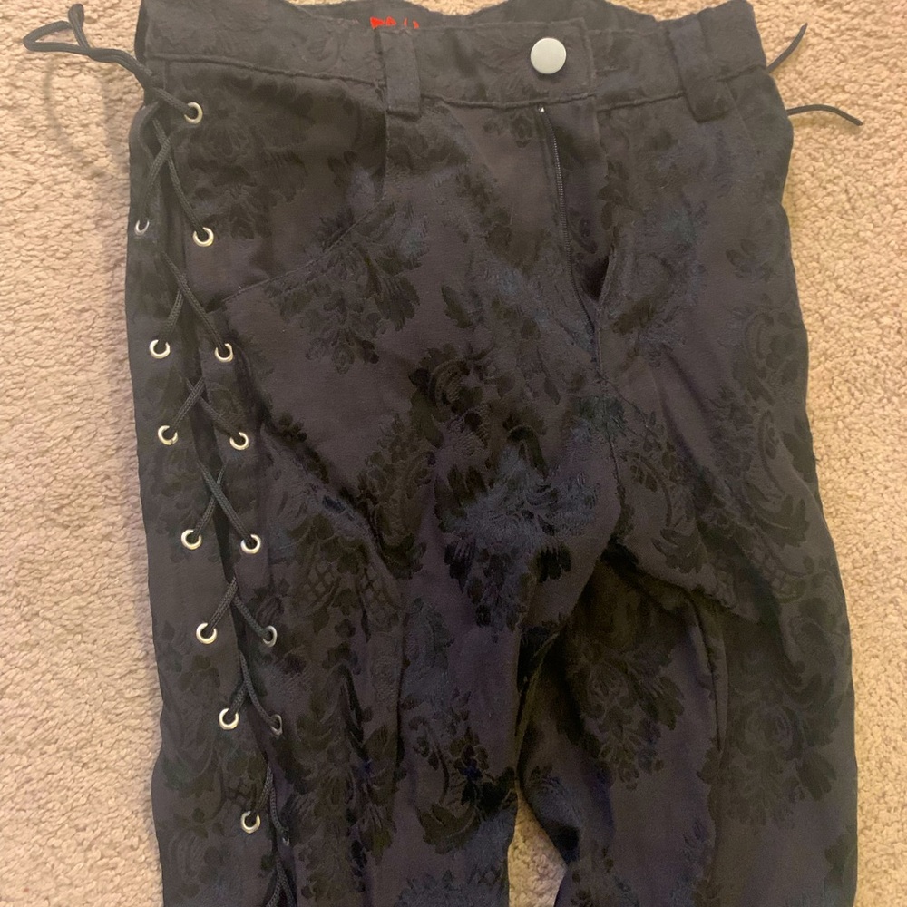 Black brocade cigarette pants with lace-up detail